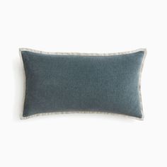 a blue and white pillow on a white background