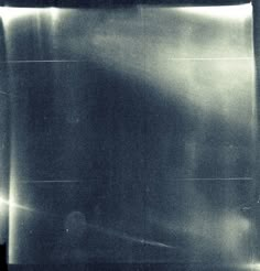 an old black and white photo of a person in the dark with their back to the camera