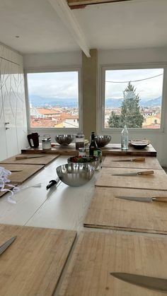 a kitchen counter with several bowls and knives on it