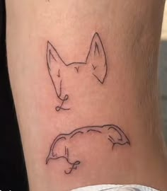 a tattoo on the leg of a woman with a dog's head in it