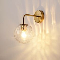 a light that is on the side of a wall next to a white wall and some lights