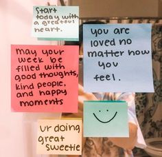 several sticky notes attached to a door with words written on them and a smiley face drawn on it