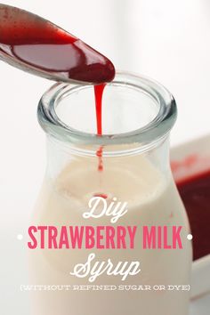 homemade strawberry milk is poured into a glass jar with the words diy strawberry milk syrup