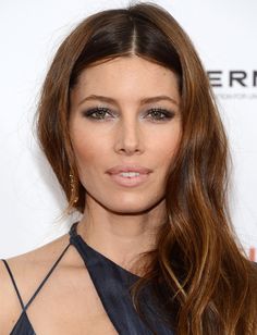 a woman with long brown hair wearing a black dress