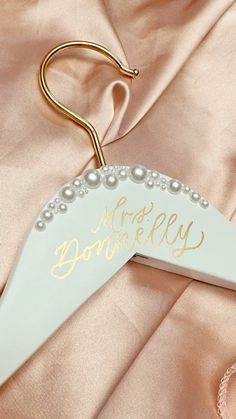 a white and gold wedding hanger with the words happily married on it's side