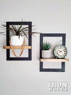 two wooden shelves with plants and an alarm clock on them, one is hanging from the wall