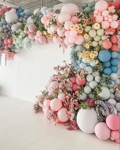 a room with balloons and flowers on the wall