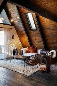 a living room filled with furniture and wooden walls