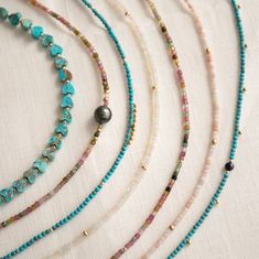 Feel the island vibes with the Endless Summer Necklace - Turqs + Caicos! This playful piece combines turquoise stones with gold fill beads and dangles, inspired by the laid-back luxury of the Turks and Caicos islands. Each piece is handmade in sunny Los Angeles, adding a touch of California cool to your look. One-of-a-kind with natural bead variations, these necklaces also come with a removable 2-inch extender, letting you style them your way. In stock necklaces will ship within 3 business days Gold Turquoise Necklace With Round Beads For Beach, Sea Glass Crafts Jewellery, Sand Necklace, Boho Jewelry Diy, The Endless Summer, Juicy Watermelon, Pave Bracelet, Pearl Gifts, Pave Beads