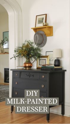 a black dresser sitting in the corner of a room