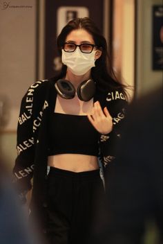 a woman wearing a face mask while walking through an airport