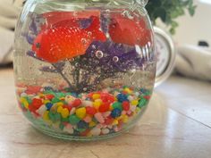 a fish bowl filled with candy and jelly beans