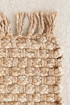 a woven piece of rope hanging on the wall