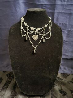 Another beautiful short gothic necklace to add to anyone's collection. This is stranded with clear quartz stones and black beads along with the white and black pearl beads and stainless steal chain. If you feel this necklace will be too small or too big, please message with neck measurements. Please remember since this is a short necklace, it is to sit along the collar bone area so the measurements you send of the neck itself I will also need the base. It should be roughly 2 to 3 inches from your neck measurements to give it that comfortable sitting position along the collar bone. Necklace With Dress, Gothic Shorts, Sitting Position, Collar Bone, Gothic Necklace, Stainless Steal, Stone Beaded Necklace, Beautiful Shorts, Short Necklace