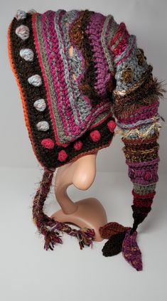 a crocheted hat on top of a mannequin's head