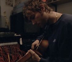 a man is working on an instrument in a room full of wires and other things