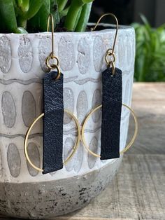 "Leather and Brass Camel Earrings Leather earrings are perfect for every outfit and any occasion from dressy to casual. So lightweight and comfortable you will forget you have them on! ITEM DETAILS - Length: 2.75\" (Including ear wire) - Width: Approx. 1.25\" - Material: Black leather and raw brass hoop. - Hardware: Raw Brass Ear Wire (Nickel and Lead Free for sensitive ears). PLEASE NOTE Raw brass is a metal alloy of copper and zinc that is NICKEL FREE. It will develop a subtle patina over time giving it the piece a more vintage look. This oxidation can be removed with a soft polishing cloth is desired.  All purchases from Orange and Prairie arrive in a linen gift bag Find more earrings here: https://www.etsy.com/shop/orangeandprairie?ref=seller-platform-mcnav&section_id=18562705 Find my Black Leather Earrings, Leather And Metal Earrings, Leather Earring Ideas, Boho Leather Jewelry, Black Leather Jewelry, Leather Jewelry Making, Handmade Leather Jewelry, Hematite Jewelry, Diy Leather Earrings