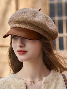 a woman wearing a brown hat and sweater