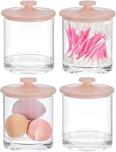 four glass containers with pink lids and eggs in them