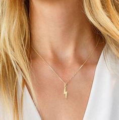 Designer's Note: Our Lightning Bolt Necklace is the perfect tiny statement necklace. Wear this beautiful necklace on its own, or paired with any of our pendant necklaces as a delicate layer. Necklace Specifications: 14k Gold filled or Sterling Silver Chain + Slider Pendant 8mm Gold Filled Pendant Link Dimensions: 0.28mm x 1.2mm x 1.25mm Links per inch: 28 Clasp: 5.5 mm Spring Ring Lightning Bolt Necklace, Layer Necklace, Lightning Bolt, Beautiful Necklace, Turks And Caicos Islands, Sterling Silver Chain, Spring Rings, Trinidad And Tobago, Caribbean Netherlands