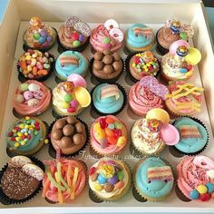 a box filled with lots of colorful cupcakes