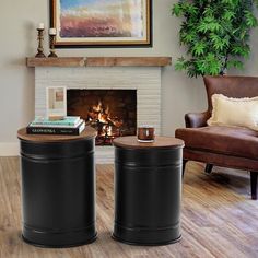 two black round tables sitting in front of a fire place next to a brown chair