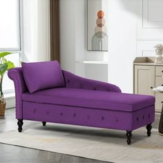 a purple chaise lounge in a white living room