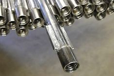 many metal tubes are lined up together