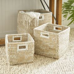 three woven baskets sitting on the floor