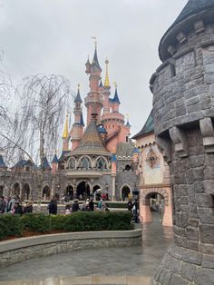 people are standing in front of a castle