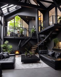 a living room filled with black furniture next to a fire place and stairs leading up to the second floor