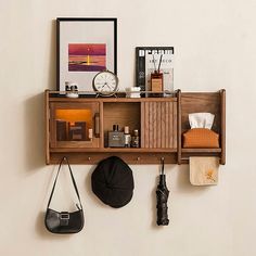 a wooden shelf with various items hanging on it's sides, including an umbrella and hat