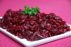 a white plate topped with cranberry sauce on top of a pink table