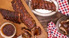 ribs and sauces are sitting on the table