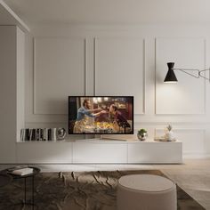 a flat screen tv sitting on top of a white entertainment center in a living room