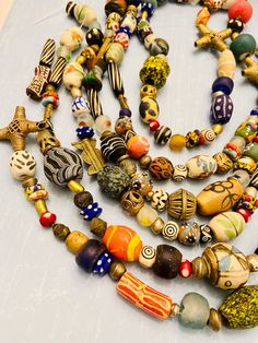 You will receive:   Assorted ethnic African & global beads. Random shapes and size-Mix rainbow colors recycled glass, ceramic, beads, African Brass, Bone beads. Cause they are totally handmade they are not perfect on shape and colors Please see all the pictures Beads are mixed RANDOMLY in no pattern. No two strands are exactly the same. amazing handmade beads, you'll love them! Material: Glass, Brass, Bone, resin Size: from 2-50mm Approximately   hole: 1-3mm Sold by strand 14" each Approximately Multicolor Wooden Beads, Unique Multicolor Wooden Beads, Multicolor Recycled Glass Bead Jewelry, Multicolor Recycled Glass Beaded Jewelry, Multicolor Bohemian Beads Fair Trade, Artisan Beaded Necklaces For Festivals, Traditional Multicolor Fair Trade Beads, Handmade Multicolor Recycled Glass Beads, Artisan Multicolor Beads