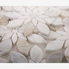 some white and black pieces of marble sitting on a table top with mesh around them