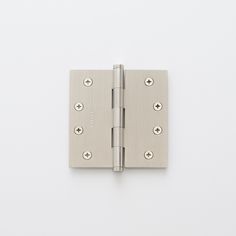 a brass plated door hinge with four screws on the front and side