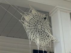 a spider web hanging from the side of a white building with text overlay that reads, zodiac wheel stylowpl