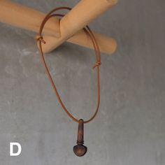 a baseball bat hanging from the side of a wall with a cord attached to it