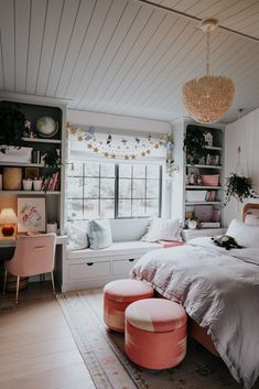 a bedroom with white walls and pink furniture