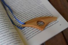 an open book with a wooden object on it