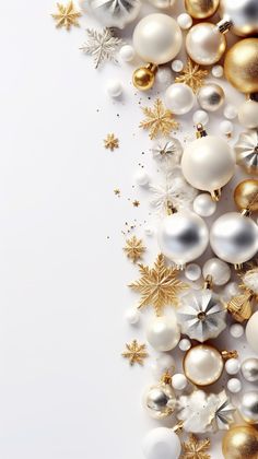 white and gold christmas ornaments with snowflakes on the bottom right corner, against a white background