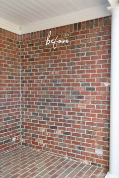 a brick wall with the words before painted on it in front of an empty room