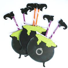 three halloween candy sticks in a black bag