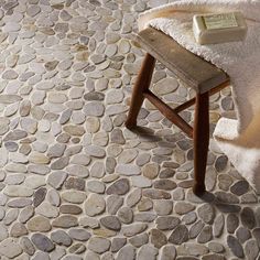 a stone floor with a bench and towel on it