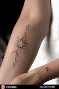 a woman's arm with a flower tattoo on the left side of her arm