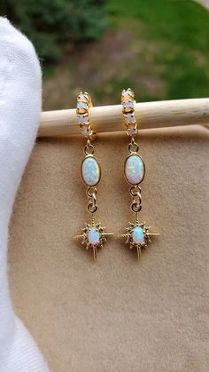 Starburst Opal Earrings  Gold huggie earrings with beautiful shine and a great celestial vibe.  Earrings: ~ 14k Gold Plated ~ With Opal Accents (the opals are synthetic man-made) 👉 Link to Our STOREFRONT: https://www.etsy.com/shop/FashionCrashJewelry?ref=shopsection_shophome_leftnav&ga_search_query=crystal%2Bnecklace Our Motto ~ Happy Customers Are Awesome 🌞Let us know of any problems or concerns with purchases. 🌞 5star reviews and positive comments are greatly appreciated, they help the succ White Sparkling Hoop Earrings As Gift, White Sparkling Hoop Earrings For Gift, Sparkling White Hoop Earrings As Gift, Celestial White Earrings, White Celestial Round Earrings, Celestial White Round Earrings, White Celestial Star Earrings, Celestial White Star Earrings, White Celestial Earrings For Gift