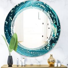 a round mirror hanging on the wall above a dresser