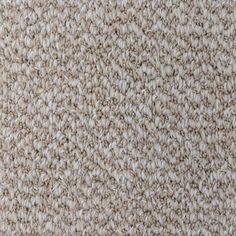 the texture of an upholstered carpet is shown in beiges and browns, as well as white